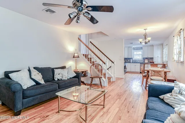 a living room with furniture and kitchen view