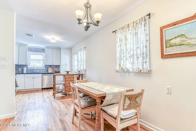 a view of a dining room with furniture and a chandelier