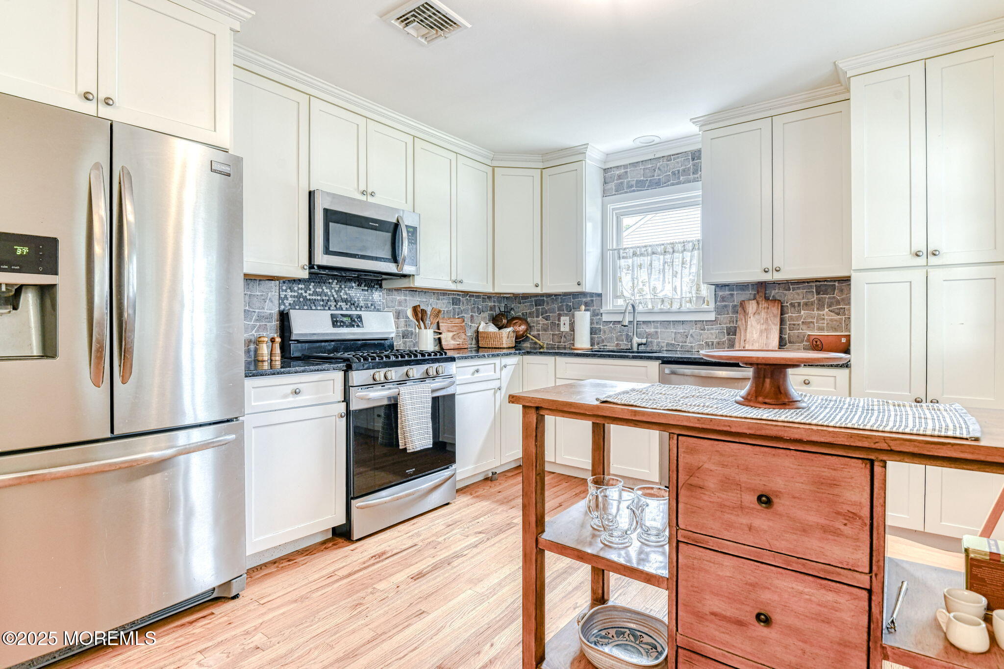 24 Peach Tree Road Oakhurst, NJ 07755 - Photo 24 of 34 a kitchen with granite countertop white cabinets and stainless steel appliances