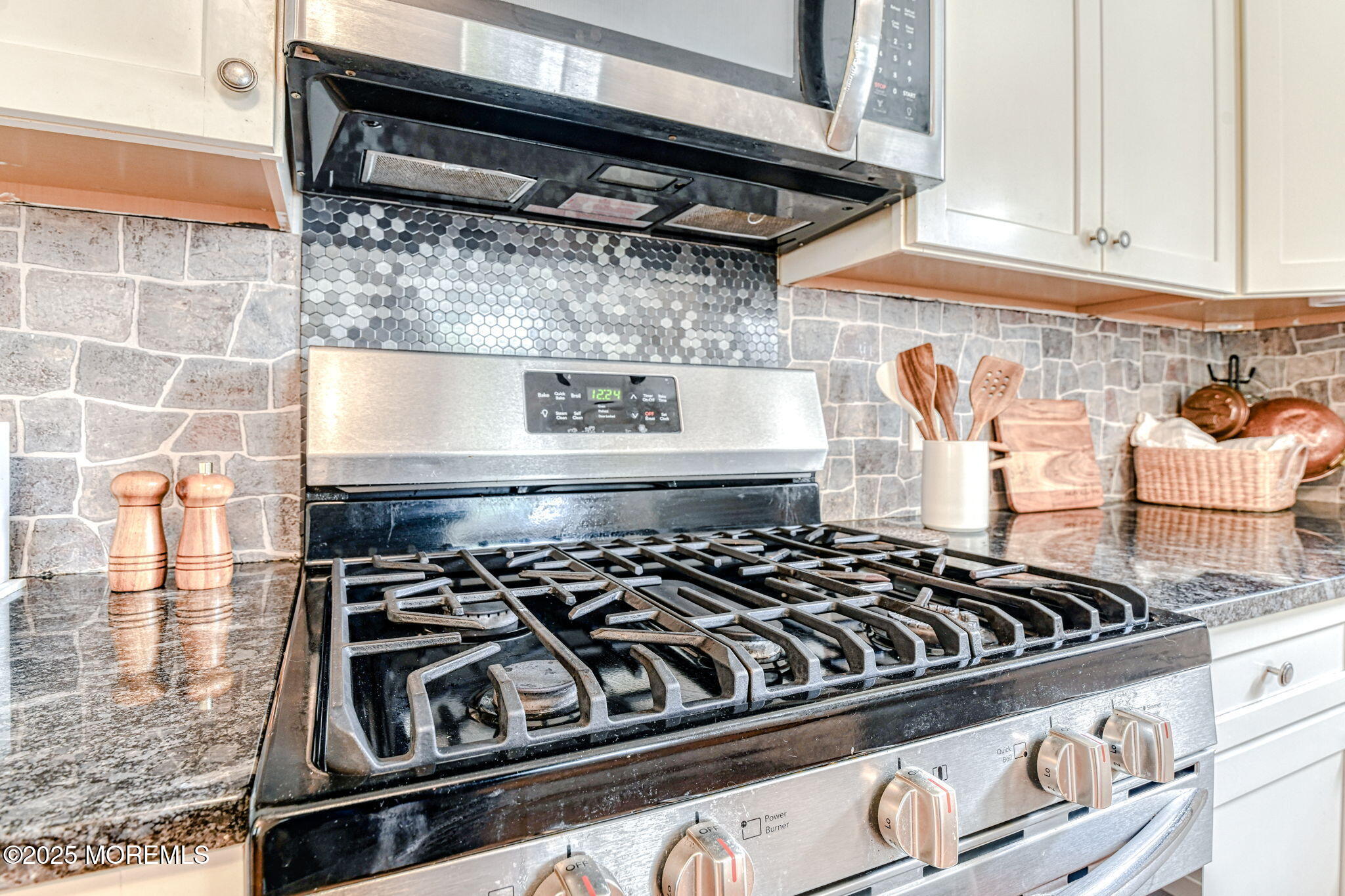 24 Peach Tree Road Oakhurst, NJ 07755 - Photo 26 of 34 a close view of a stove a microwave and cabinets