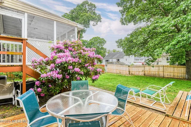 a view of an house with backyard and sitting area