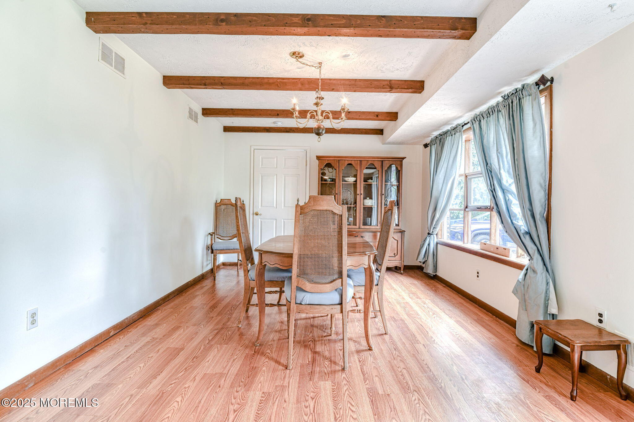 24 Peach Tree Road Oakhurst, NJ 07755 - Photo 3 of 34 a dining room with wooden floors and a rug