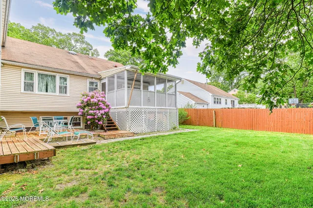 a view of a house with backyard sitting area and garden