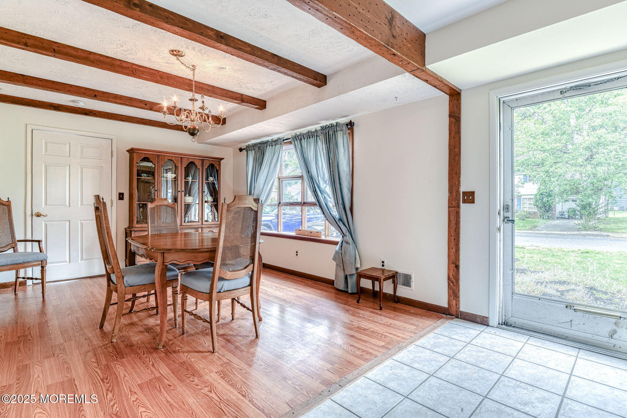 24 Peach Tree Road Oakhurst, NJ 07755 - Photo 4 of 34 a dining room with wooden floor a glass table and windows