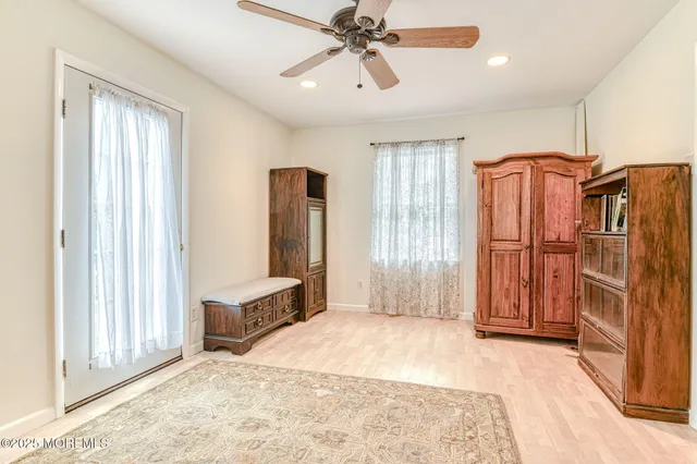 a view of a bedroom with furniture and windows