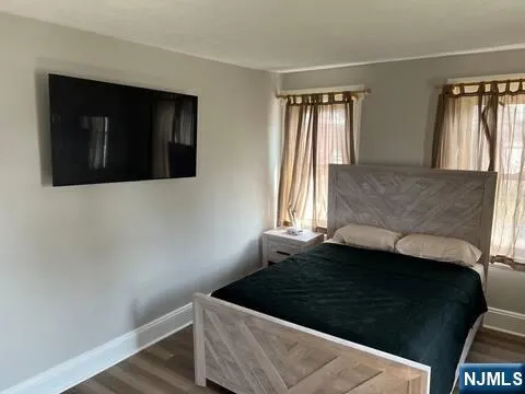 a bathroom with a toilet a sink a bath tub and mirror