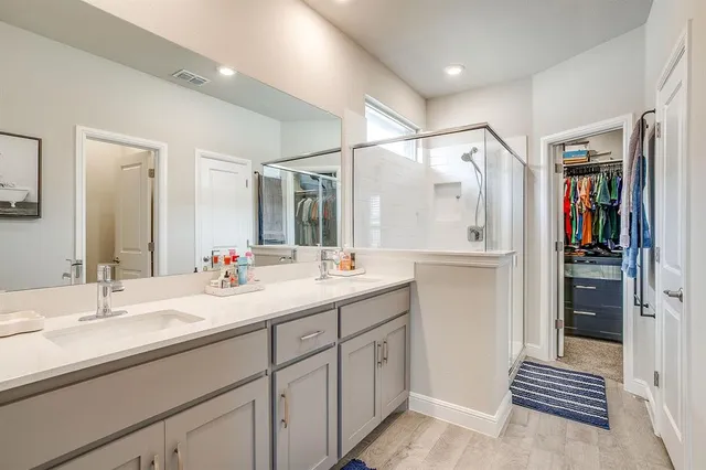 a view of walk in closet with clothes