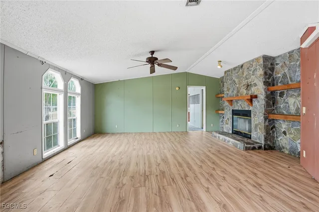 a view of a livingroom with wooden floor and a ceiling fan