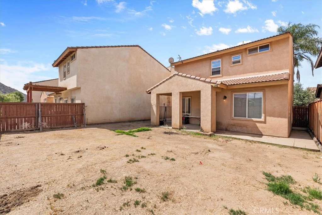 1474 Albillo Loop Perris, CA 92571 - Photo 30 of 35 a front view of a house with a dirt road