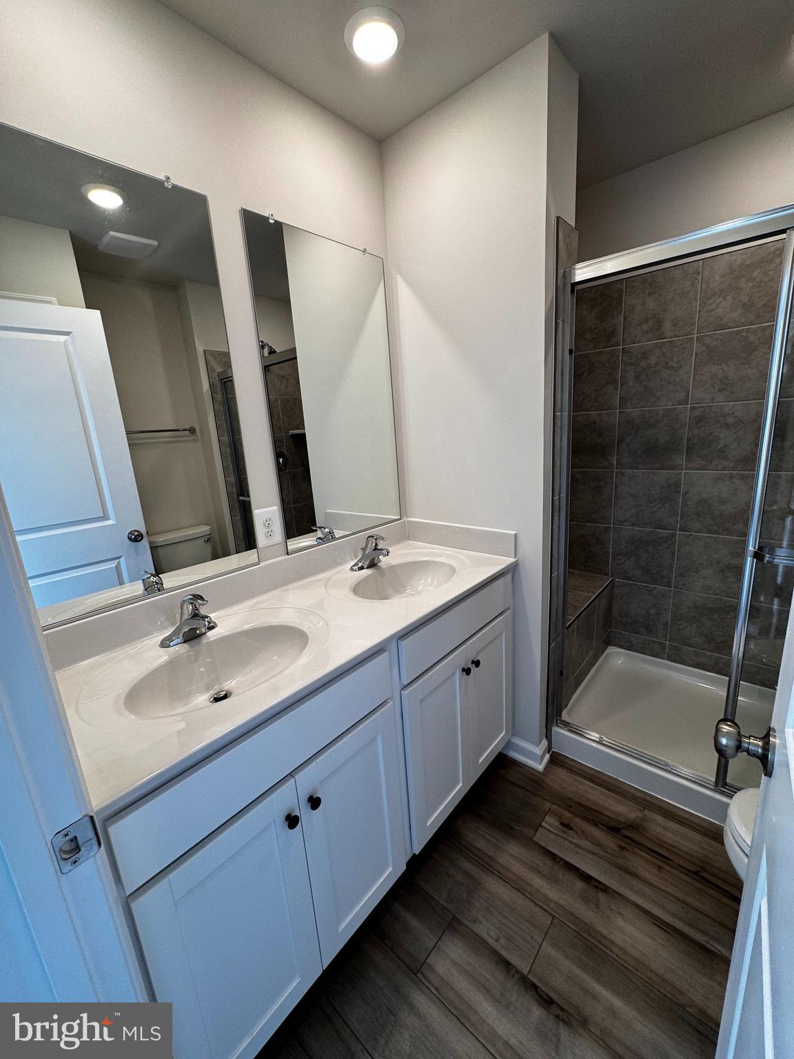 1258 Red Clover Lane Ranson, WV 25438 - Photo 12 of 25 a bathroom with a double vanity sink and a mirror