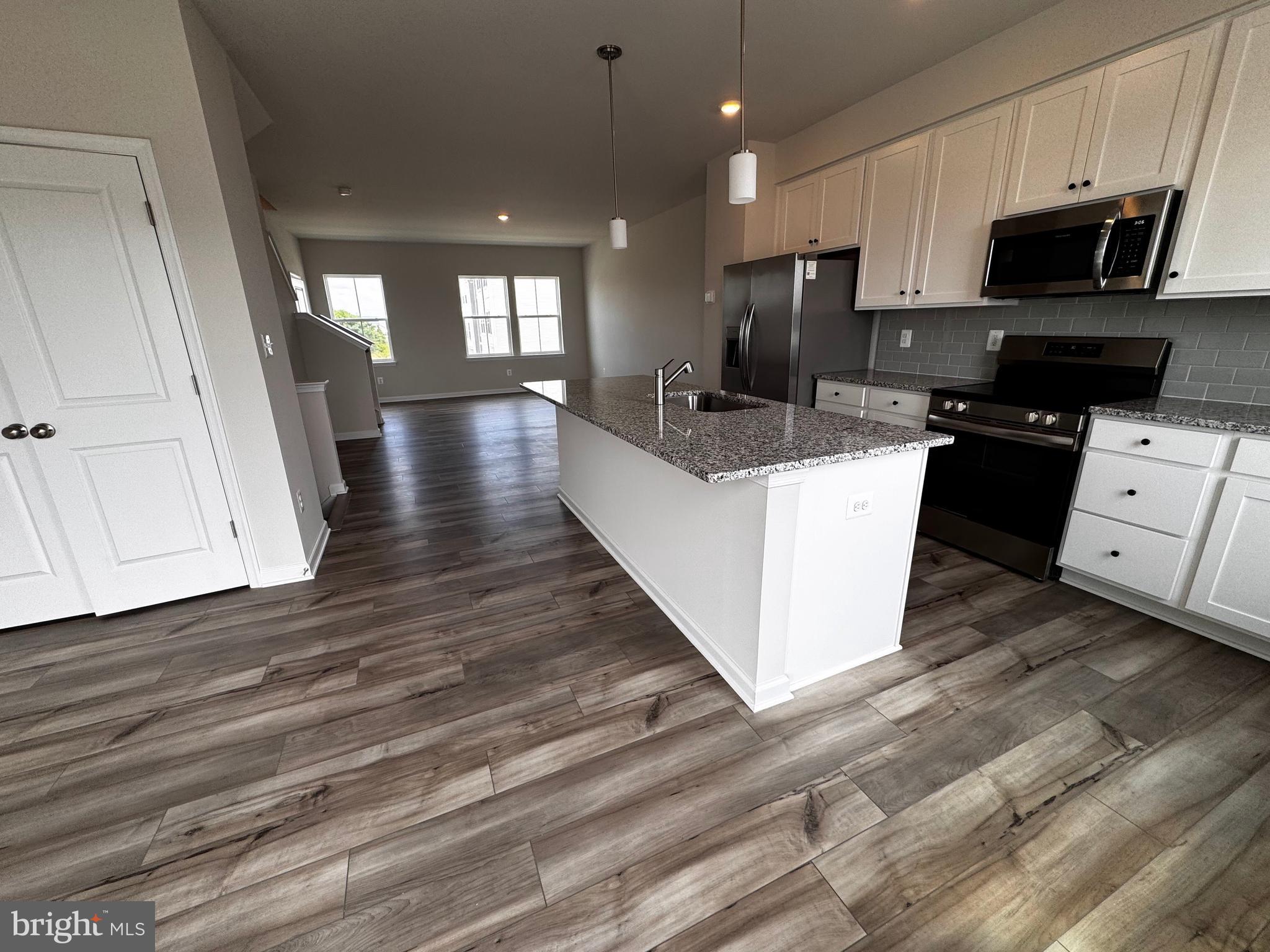 1258 Red Clover Lane Ranson, WV 25438 - Photo 25 of 25 a large kitchen with stainless steel appliances granite countertop a stove a sink a refrigerator and a microwave
