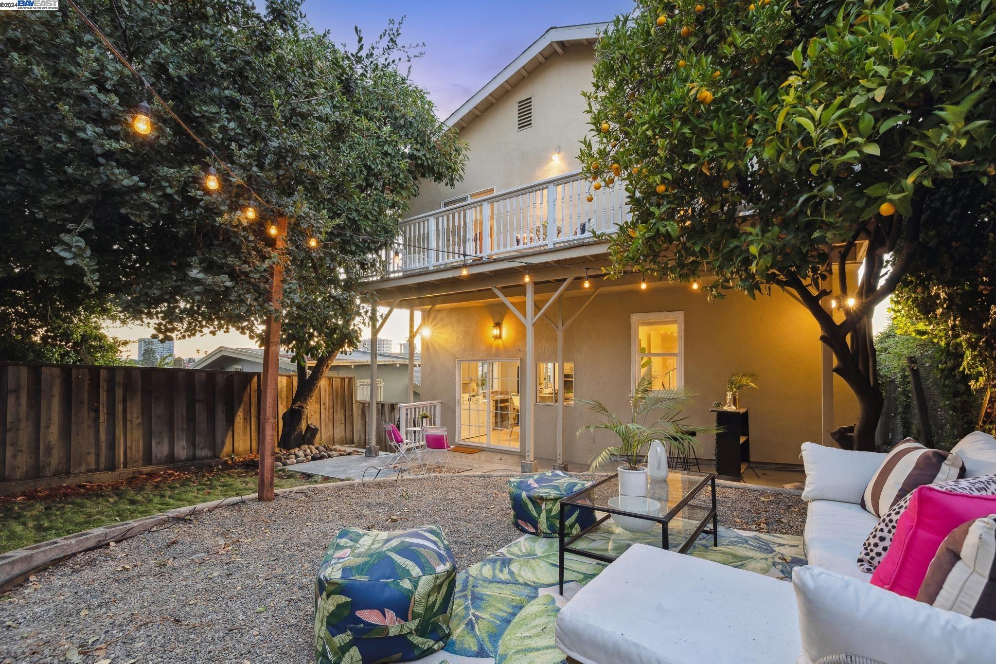 1932 5th Avenue Oakland, CA 94606 - Photo 1 of 1 a view of a patio with couches and table and chairs and wooden fence