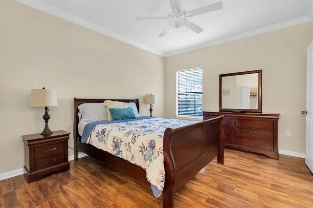 a bedroom with a bed and wooden floor