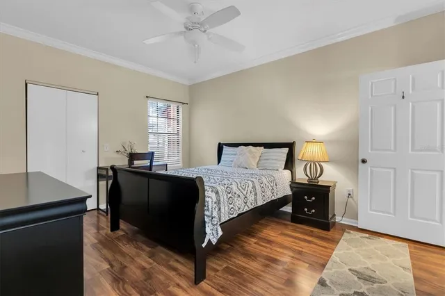 a bedroom with a bed and wooden floor