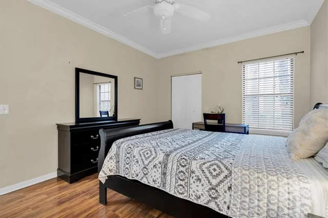 a bedroom with a bed and wooden floor