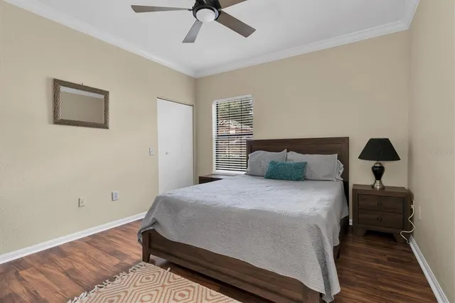 a bedroom with bed and wooden floor