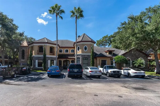 a couple of cars parked in front of a house
