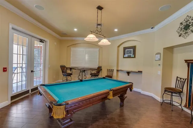 a room with furniture pool table and windows