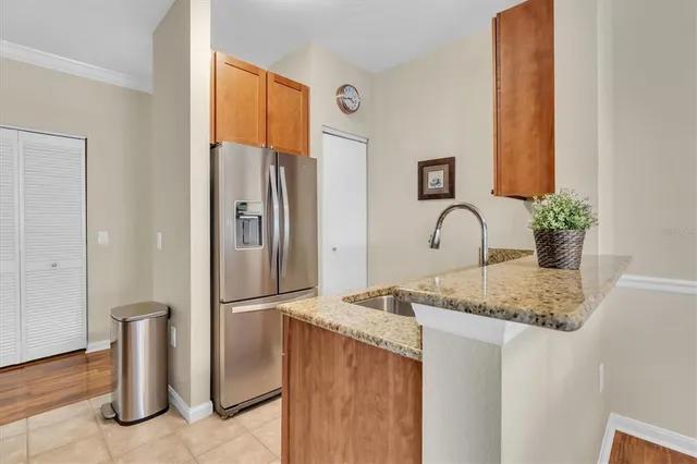 a kitchen with a refrigerator and a counter top space