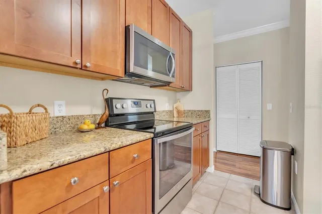a kitchen with granite countertop a sink and a stove top oven