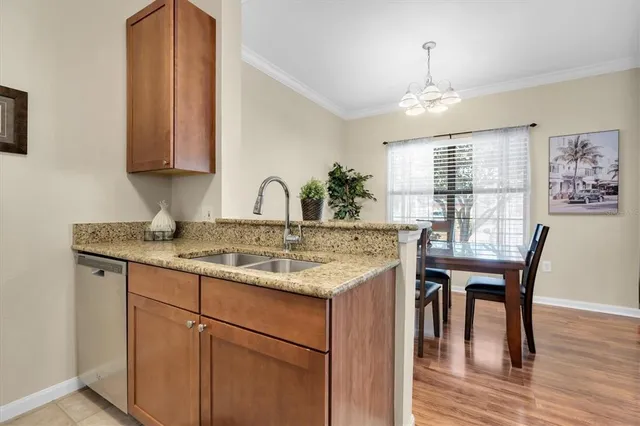 a kitchen with a table chairs and wooden floor