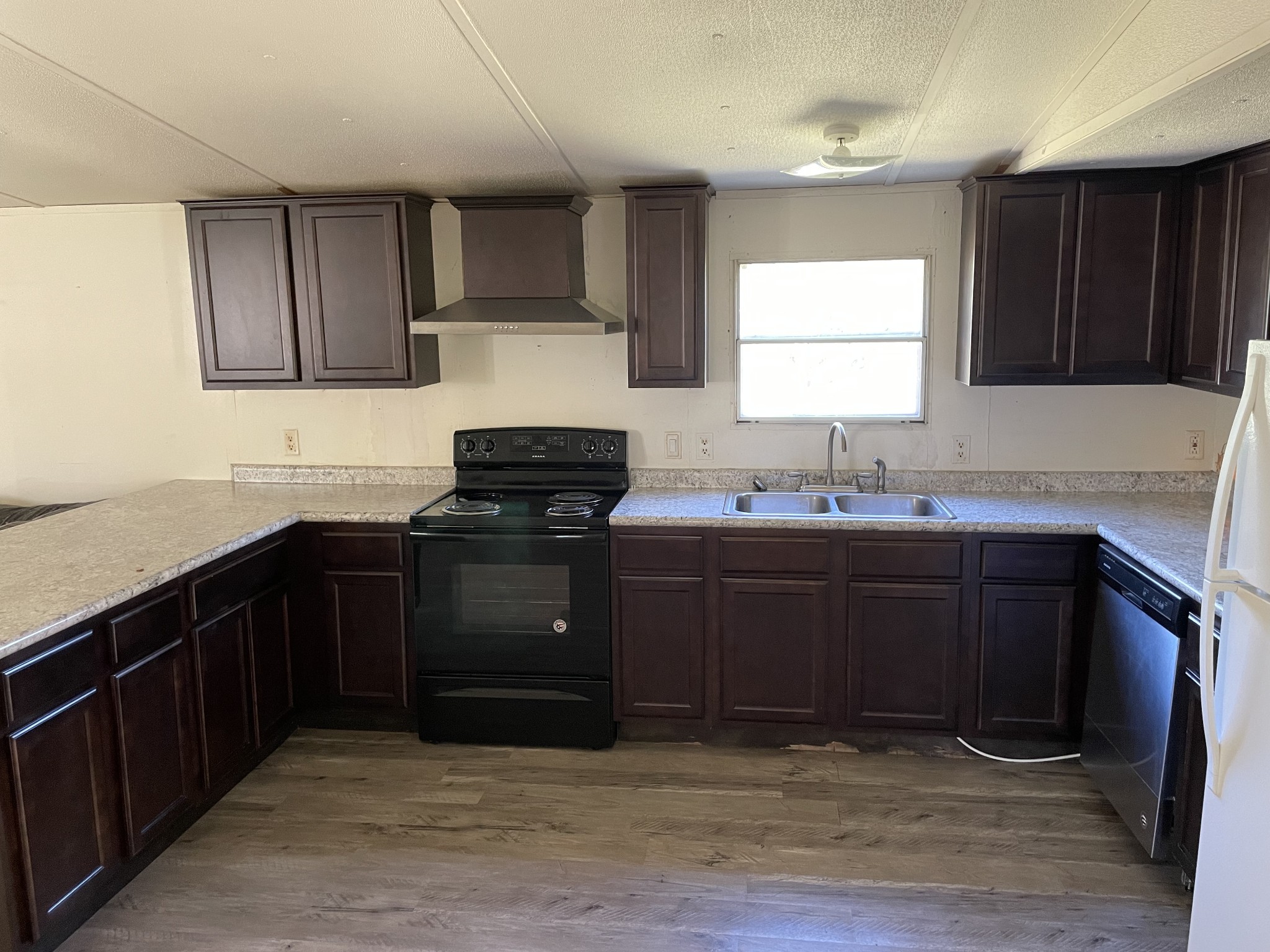 82 Ben Thompson Road Kelso, TN 37348 - Photo 5 of 13 a kitchen with granite countertop a sink cabinets and stainless steel appliances