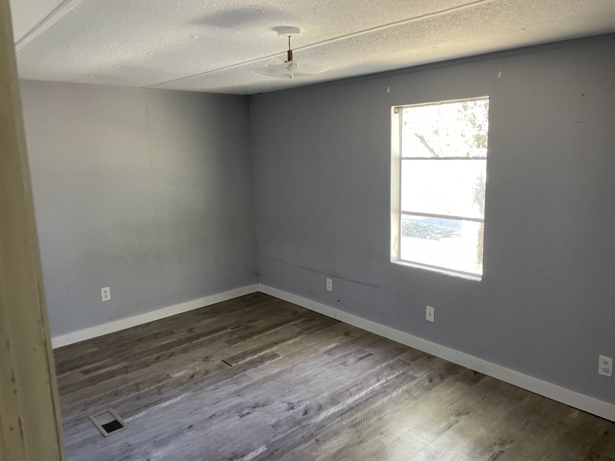 82 Ben Thompson Road Kelso, TN 37348 - Photo 8 of 13 an empty room with wooden floor and windows