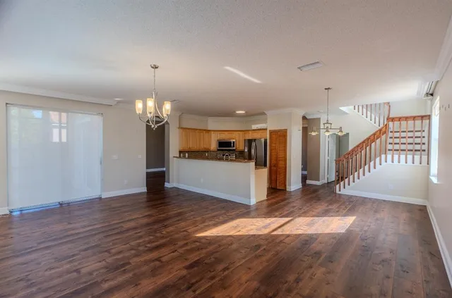 a view of a room with wooden floor