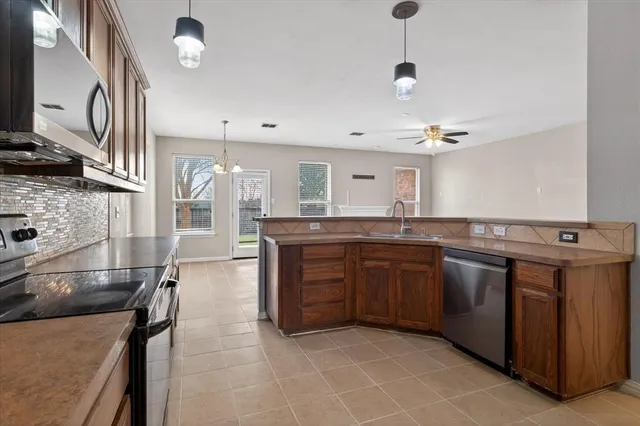 a large kitchen with a stove and a sink