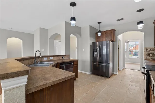 a kitchen with refrigerator and cabinets