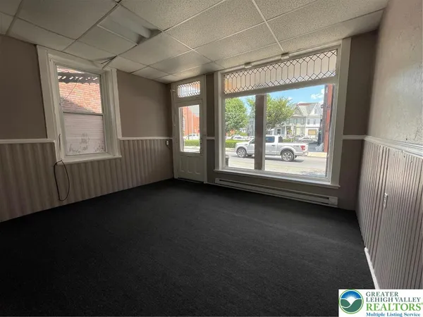 a view of a livingroom with an empty space and a window