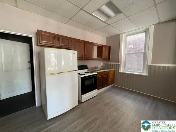 a kitchen with stainless steel appliances a refrigerator sink and microwave