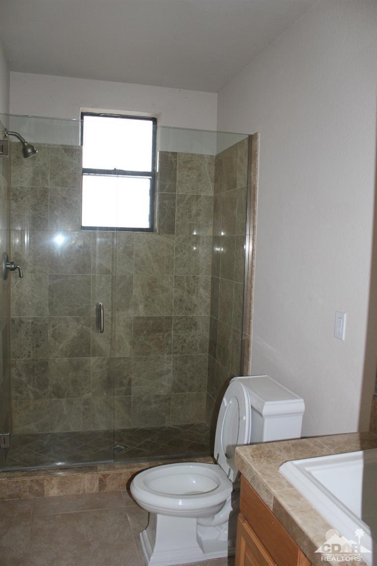 53966 Ridge Road Yucca Valley, CA 92284 - Photo 14 of 20 a bathroom with a toilet and a shower