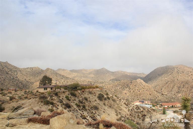 53966 Ridge Road Yucca Valley, CA 92284 - Photo 20 of 20 a view of a mountain range in a cloudy sky
