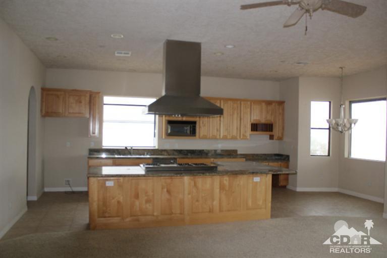 53966 Ridge Road Yucca Valley, CA 92284 - Photo 4 of 20 a kitchen with kitchen island granite countertop a stove and a sink