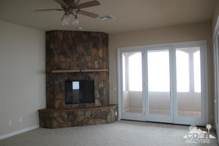 53966 Ridge Road Yucca Valley, CA 92284 - Photo 9 of 20 a living room with furniture and a fireplace