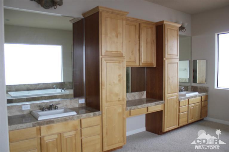 53966 Ridge Road Yucca Valley, CA 92284 - Photo 10 of 20 a bathroom with a double vanity sink a mirror and a bathtub
