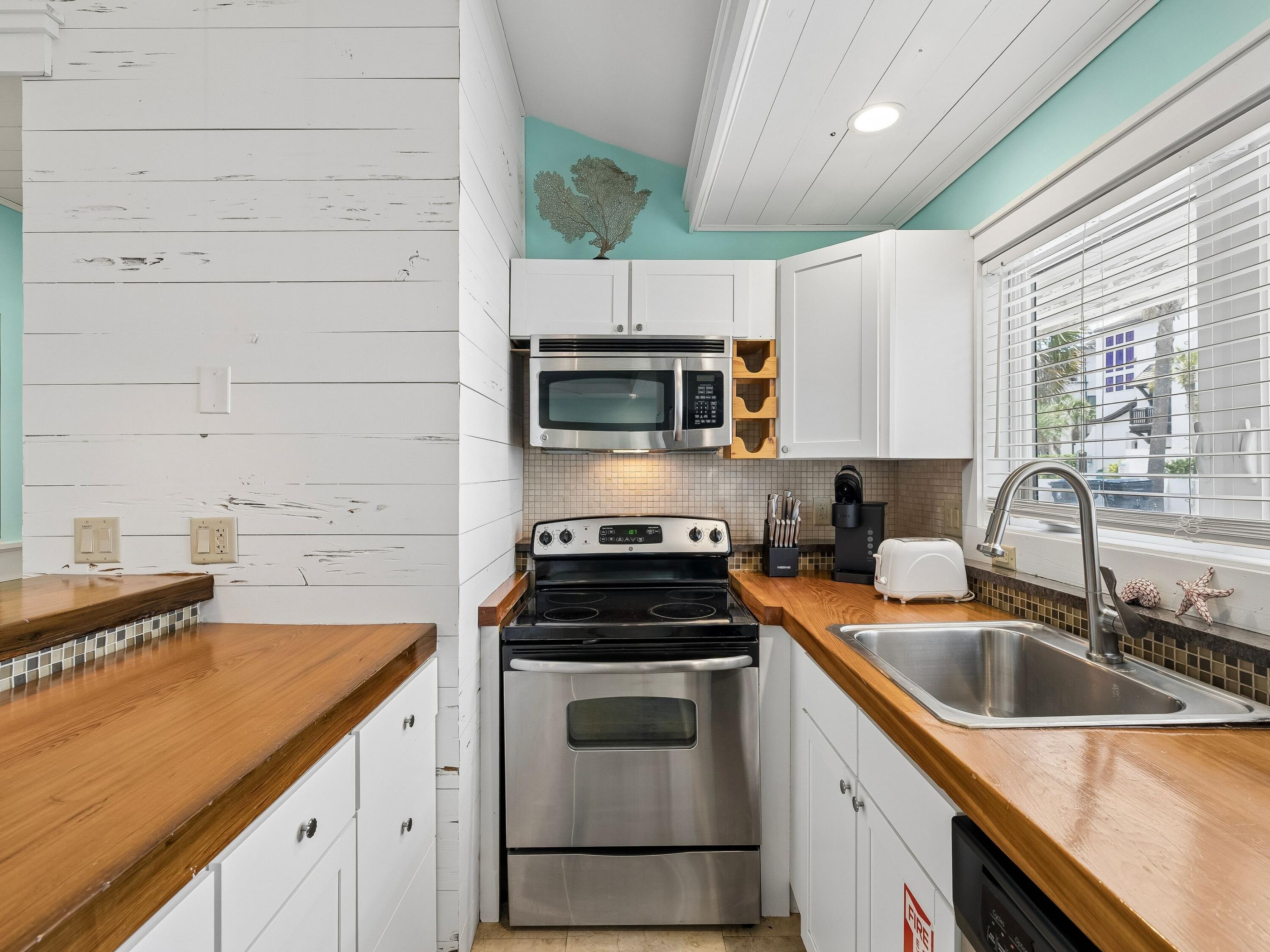 36 Green Street Inlet Beach, FL 32461 - Photo 19 of 27 a kitchen with a sink stove and microwave