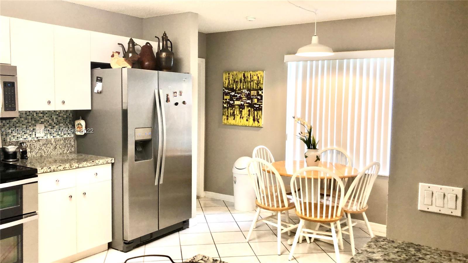 Savanna Weston, FL 33327 - Photo 6 of 7 a kitchen with a refrigerator and a table