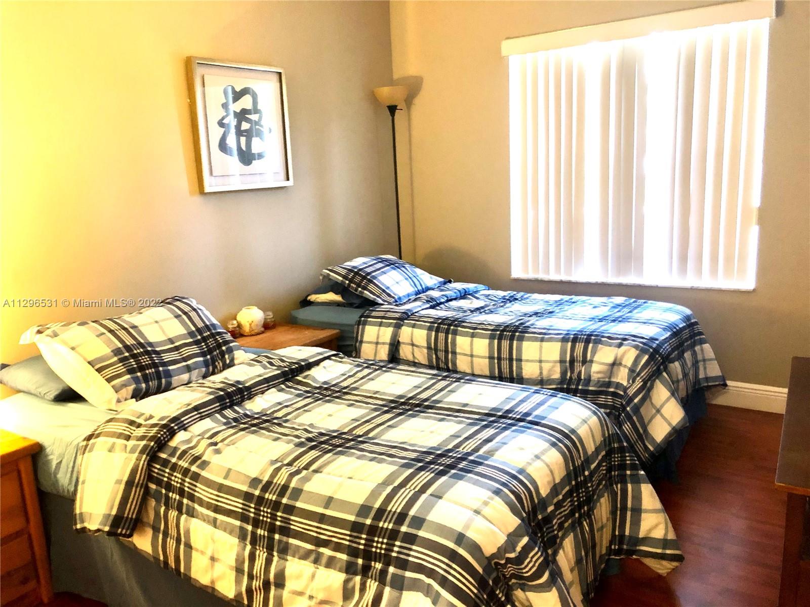 Savanna Weston, FL 33327 - Photo 7 of 7 a bedroom with a bed and a window