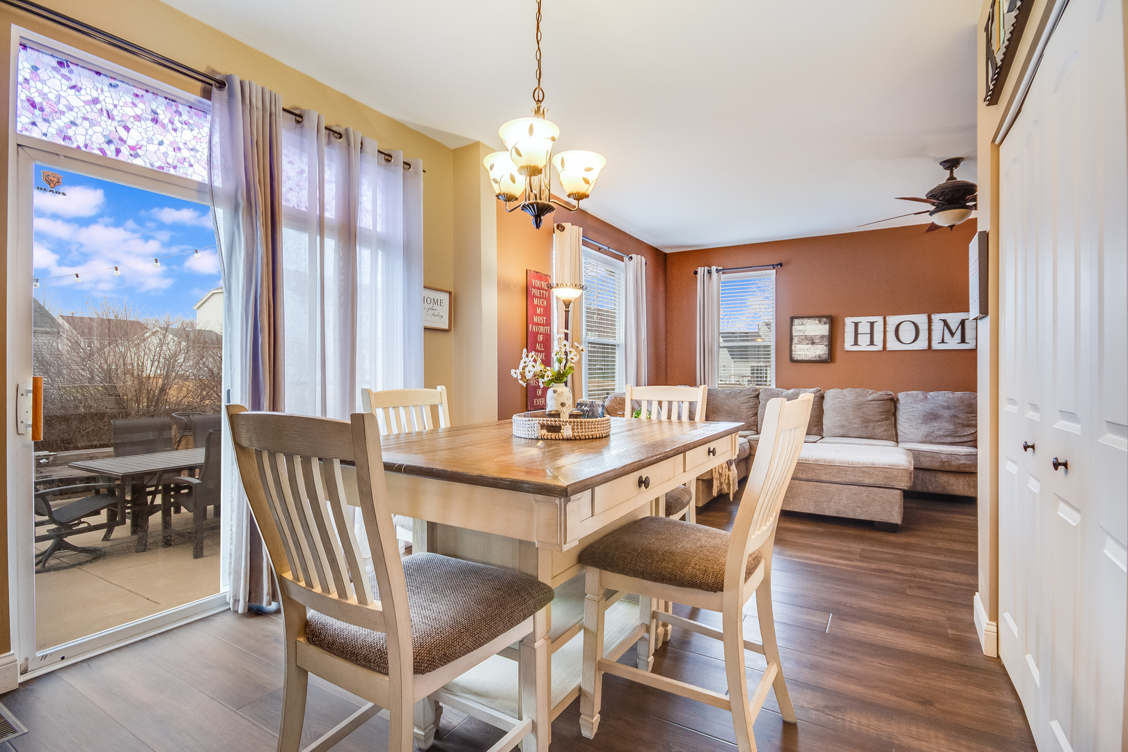 7654 Pin Oak Court Plainfield, IL 60586 - Photo 11 of 41 a view of a dining room with furniture window and wooden floor