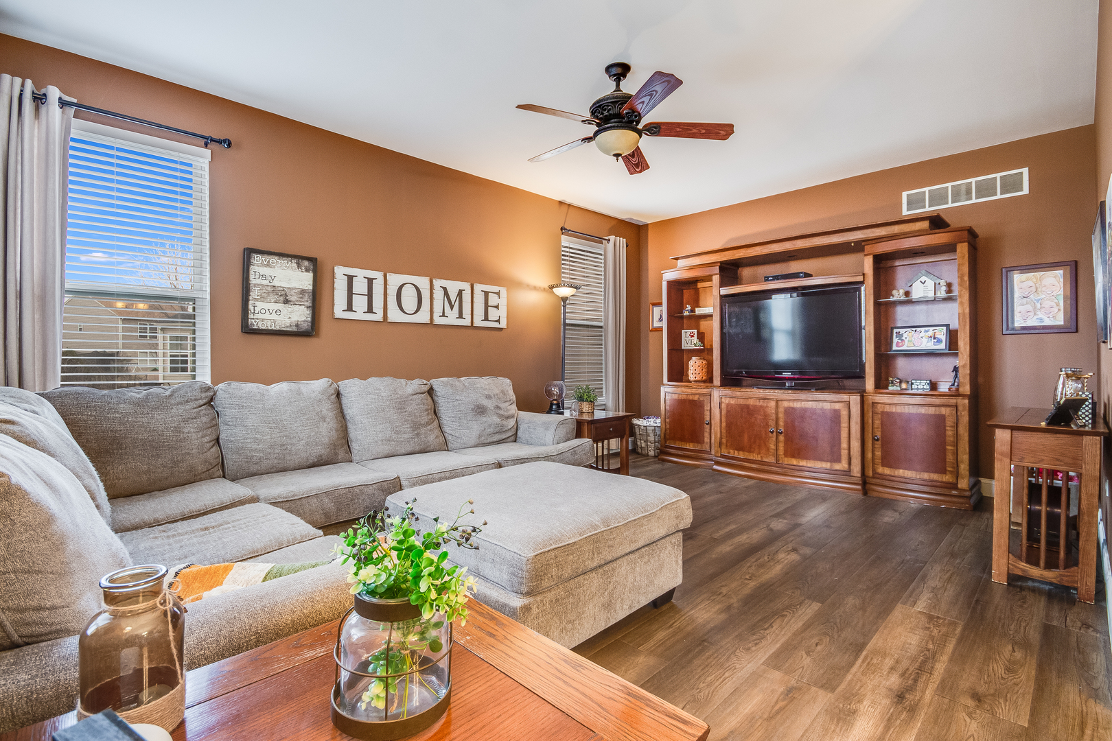 7654 Pin Oak Court Plainfield, IL 60586 - Photo 12 of 41 a living room with furniture and a flat screen tv