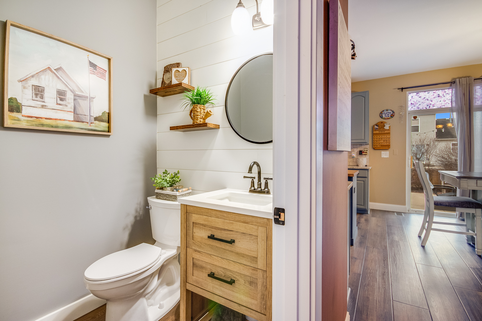 7654 Pin Oak Court Plainfield, IL 60586 - Photo 14 of 41 a bathroom with a toilet a sink and wooden floor