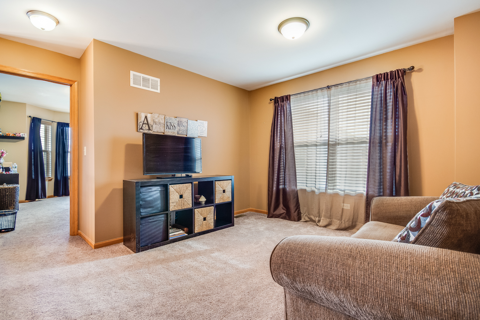 7654 Pin Oak Court Plainfield, IL 60586 - Photo 17 of 41 a living room with furniture and a flat screen tv