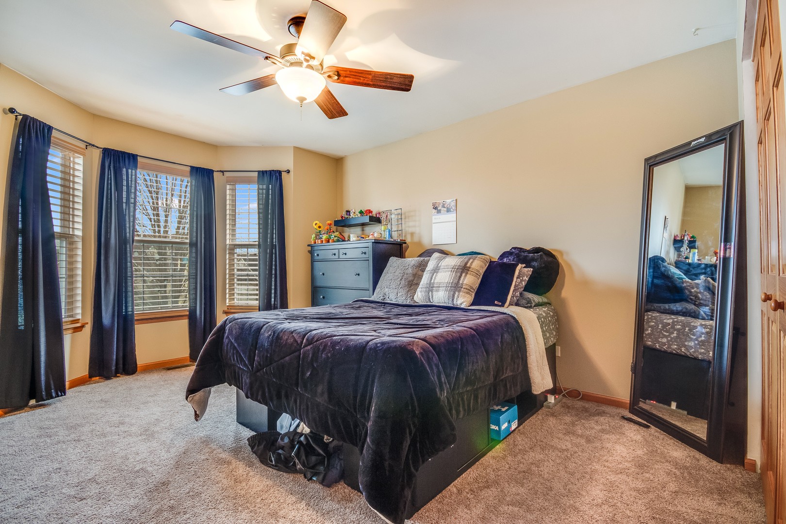 7654 Pin Oak Court Plainfield, IL 60586 - Photo 19 of 41 a bedroom with a bed and a chandelier