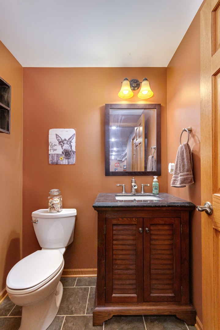 7654 Pin Oak Court Plainfield, IL 60586 - Photo 28 of 41 a bathroom with a toilet a sink and mirror