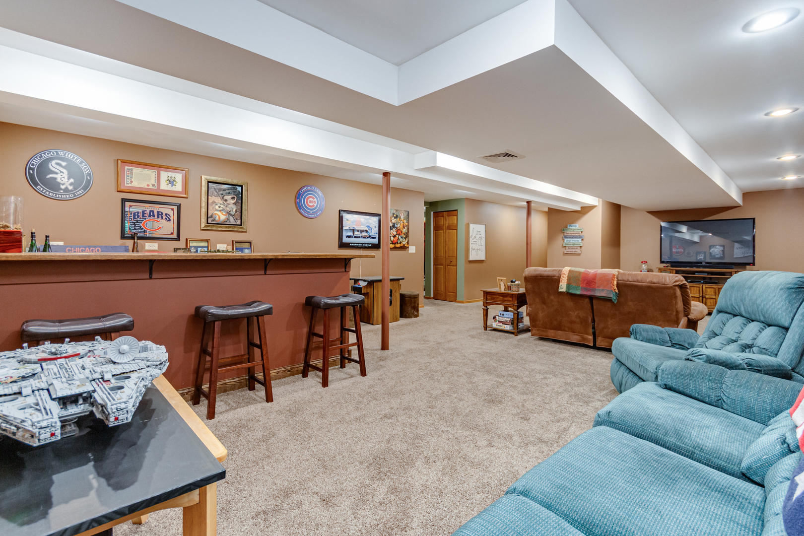 7654 Pin Oak Court Plainfield, IL 60586 - Photo 29 of 41 a living room with furniture and a flat screen tv