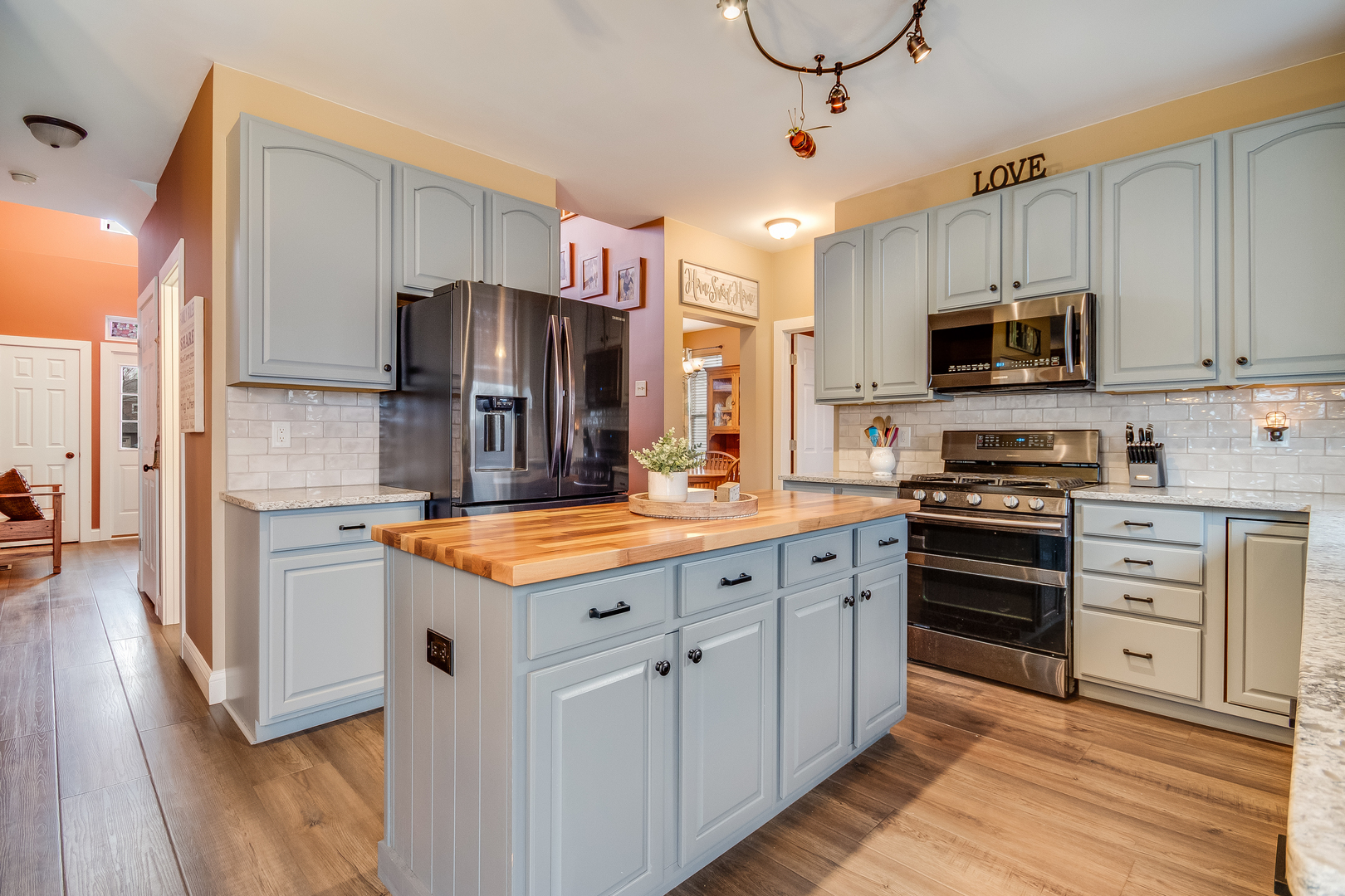 7654 Pin Oak Court Plainfield, IL 60586 - Photo 7 of 41 a kitchen with stainless steel appliances granite countertop a stove top oven a refrigerator and a sink