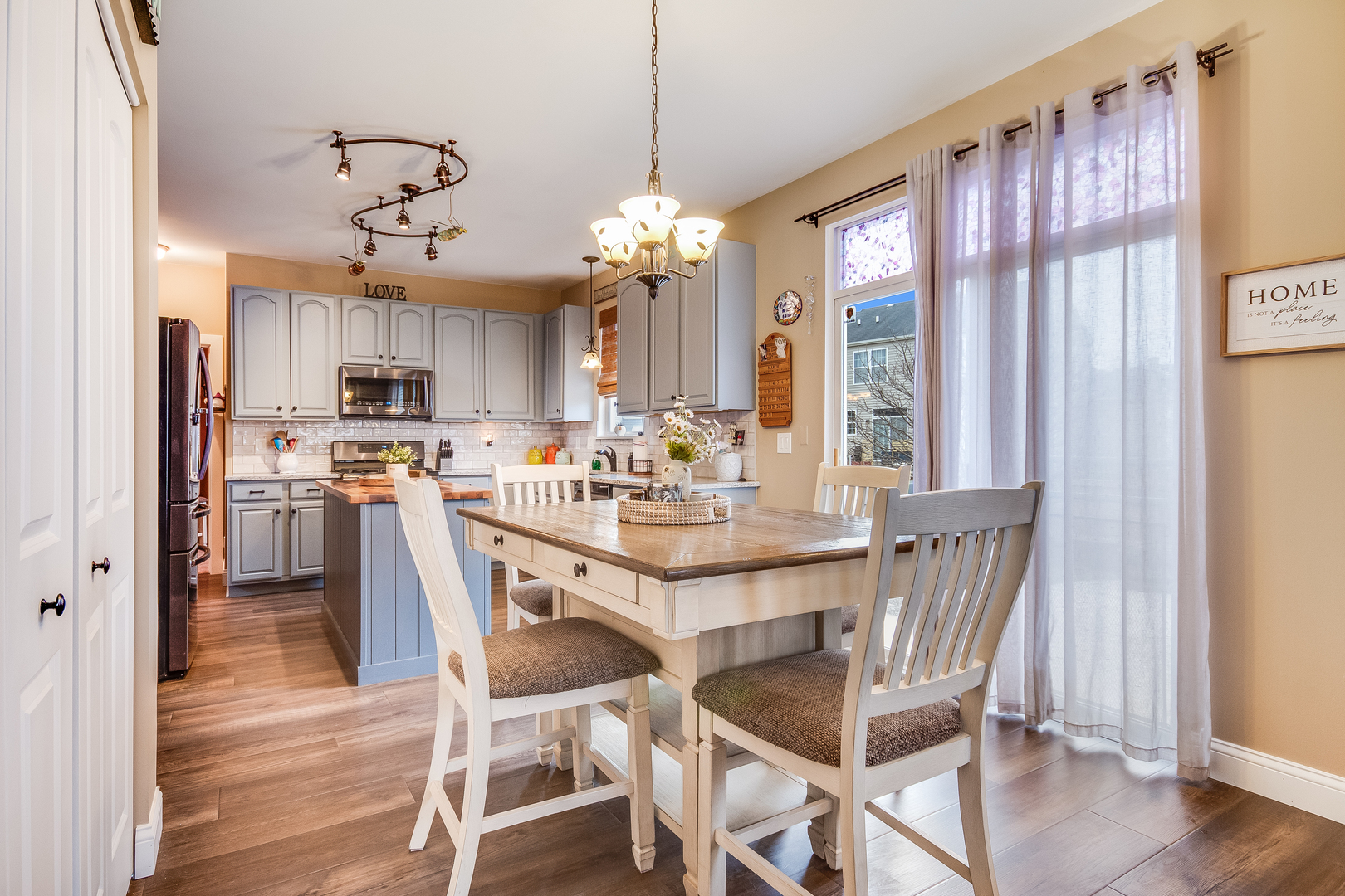 7654 Pin Oak Court Plainfield, IL 60586 - Photo 10 of 41 a view of a dining room with furniture window and wooden floor