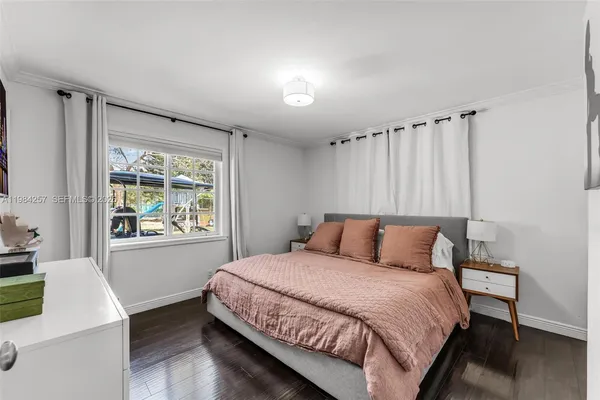 a bedroom with a large bed and a window